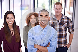 Were persistent in our search for success. Portrait of a team of designers standing together in an office.