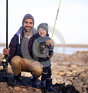 Were ready to catch a giant. Portrait of a loving father and son fishing by the sea.