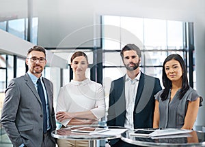 Were a team of overachievers. Cropped portrait of a group of businesspeople standing in the office.