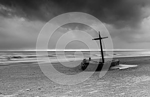 Wereck boat on the beach with storm cloud