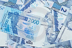 A West African franc bank note with a background of Brazilian two real bills