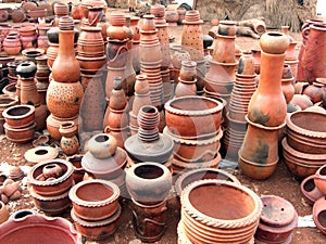 West African pottery stacked for sale