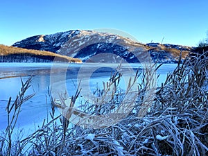 West coast of Norway at a winterday with ice and snow at the lake in VikesÃ¥ photo