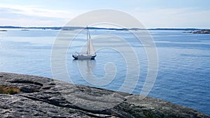 WEST COAST, SWEDEN: A SAILBOAT MOVES SLOWLY OVER THE WATER