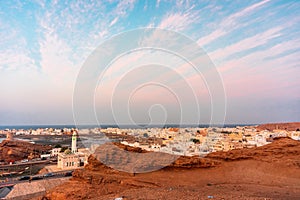 West part of Sur town with Al-Ayjah Castle, mosque in golden hour time, Oman