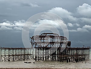 The West Pier, Brighton, under a dark, gloomy sky