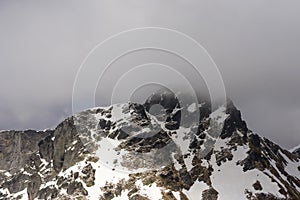 West side of Tre Signori peak summit among clouds, Orobie
