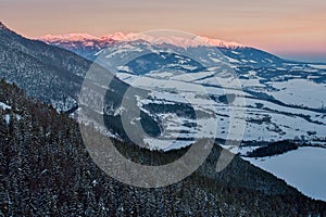 West Tatras from Janosikov stol rock over Liptovska Anna village in Chocske vrchy mountains during winter