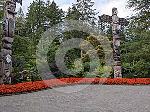 Westcoast native carved Totem poles displayed at the Butchart Gardens in Victoria BC Canada