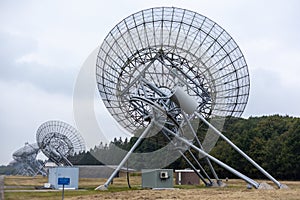 Westerbork Synthesis Radio Telescope surrounded by forests under a cloudy sky in the Netherlands