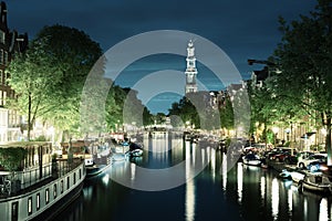 Westerkerk church tower at canal in Amsterdam