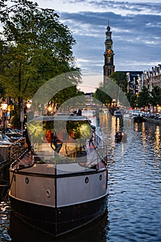 Westerkerk and Houseboat at Sunset in Amsterdam