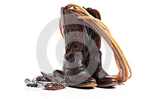 Western boots and a lap or lariat rope and spurs on a white background photo