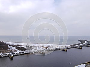 Western breakwater in the city of Kolobrzeg in winter, entrance to the port, estuary of the Parseta River to the Baltic Sea in Pol photo