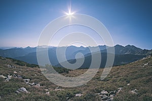 Western carpathian mountain tops in autumn covered in mist or clouds with blue cast and multidimensional lines - vintage old film