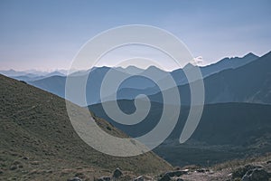 Western carpathian mountain tops in autumn covered in mist or clouds with blue cast and multidimensional lines - vintage old film