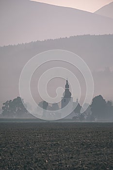 Western carpathian mountain tops in autumn covered in mist or clouds with blue cast and multidimensional lines - vintage old film