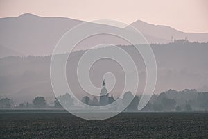 Western carpathian mountain tops in autumn covered in mist or clouds with blue cast and multidimensional lines - vintage old film