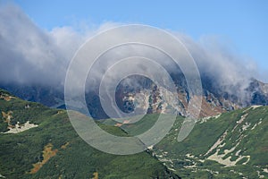 Mountain tops in autumn covered in mist or clouds