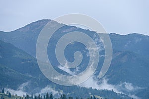 Mountain tops in autumn covered in mist or clouds