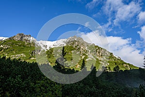 Mountain tops in autumn covered in mist or clouds in sunny day