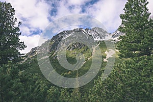 Mountain tops in autumn covered in mist or clouds in sunny day-