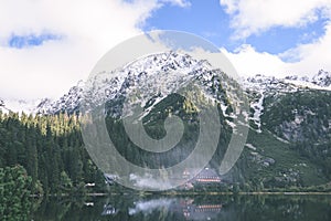 Mountain tops in autumn covered in mist or clouds in sunny day-