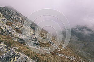 Mountain tops in autumn covered in mist or clouds- vintage effe