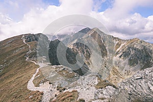 Mountain tops in autumn covered in mist or clouds- vintage effe