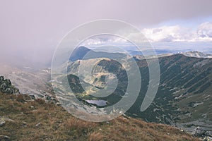 Mountain tops in autumn covered in mist or clouds- vintage effe