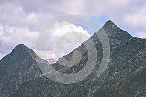 Mountain tops in autumn covered in mist or clouds- vintage effe