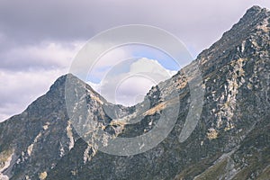 Mountain tops in autumn covered in mist or clouds- vintage effe