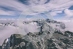 Mountain tops in autumn covered in mist or clouds- vintage effe