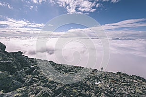 Mountain tops in autumn covered in mist or clouds- vintage effe