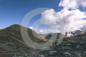 Mountain tops in autumn covered in mist or clouds - vintage ret