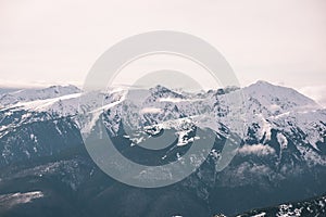 Mountain tops in winter covered in snow - vintage film look