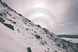 Mountain tops in winter covered in snow - vintage film look