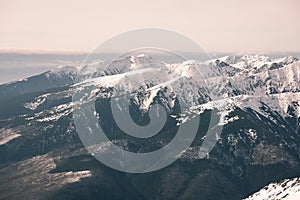 Mountain tops in winter covered in snow - vintage film look