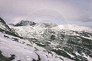 Mountain tops in winter covered in snow - vintage film look