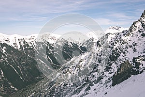 Mountain tops in winter covered in snow - vintage film look