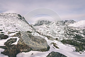 Mountain tops in winter covered in snow - vintage film look