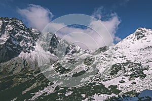 Mountain tops in winter covered in snow - vintage retro look