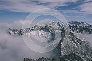 Mountain tops in winter covered in snow - vintage retro look