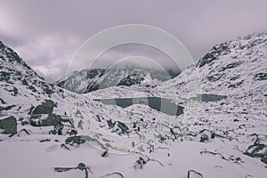 Mountain tops in winter covered in snow - vintage retro look