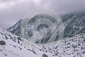 Mountain tops in winter covered in snow - vintage retro look