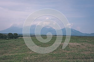 Western carpathian Tatra mountain skyline with green fields and forests in foreground. summer in Slovakian hiking trails - vintage