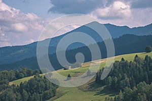 Western carpathian Tatra mountain skyline with green fields and forests in foreground. summer in Slovakian hiking trails - vintage