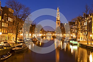 The Western Church and a canal in Amsterdam at night