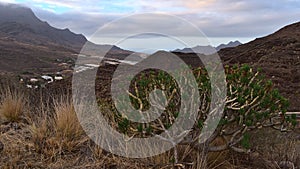 Western coast of island Gran Canaria, Spain with remote village La Aldea de San Nicolas surrounded by rugged mountains.