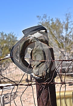 Western cowboy boot hanging on a post